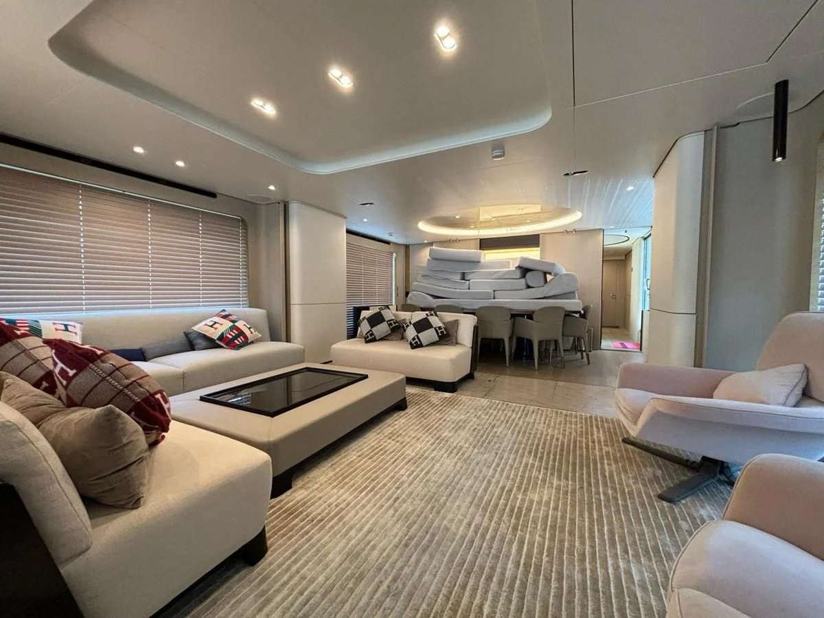 a living room with a large white couch and a white rug aboard INFINITE VOYAGE III Yacht for Sale