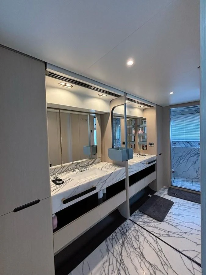 a large bathroom with a large mirror aboard INFINITE VOYAGE III Yacht for Sale