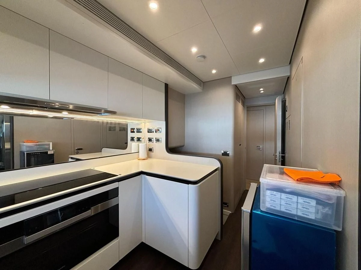 a kitchen with white cabinets aboard INFINITE VOYAGE III Yacht for Sale