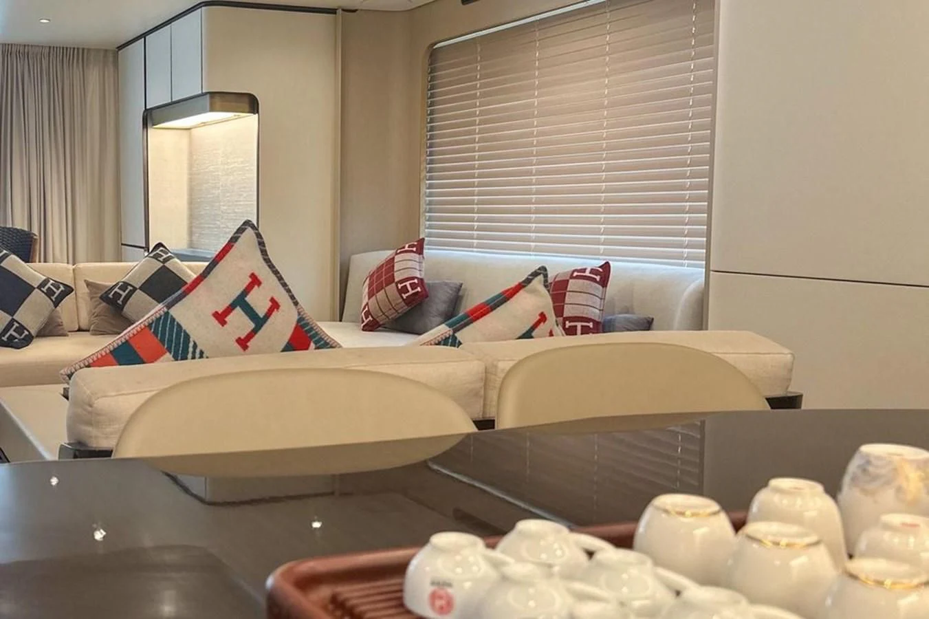 a room with a bed and a table with a chair aboard INFINITE VOYAGE III Yacht for Sale