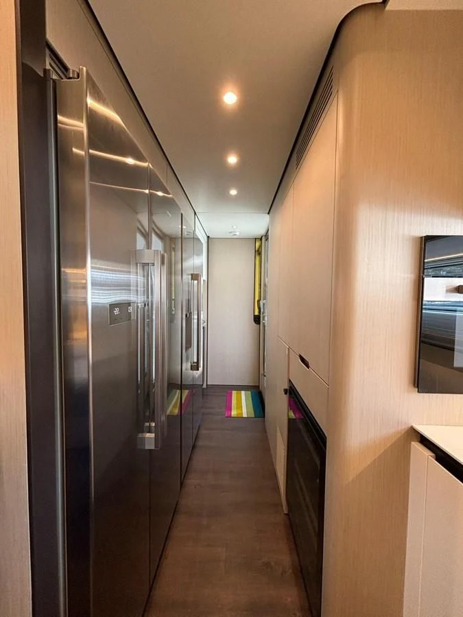 a hallway with a door and windows aboard INFINITE VOYAGE III Yacht for Sale