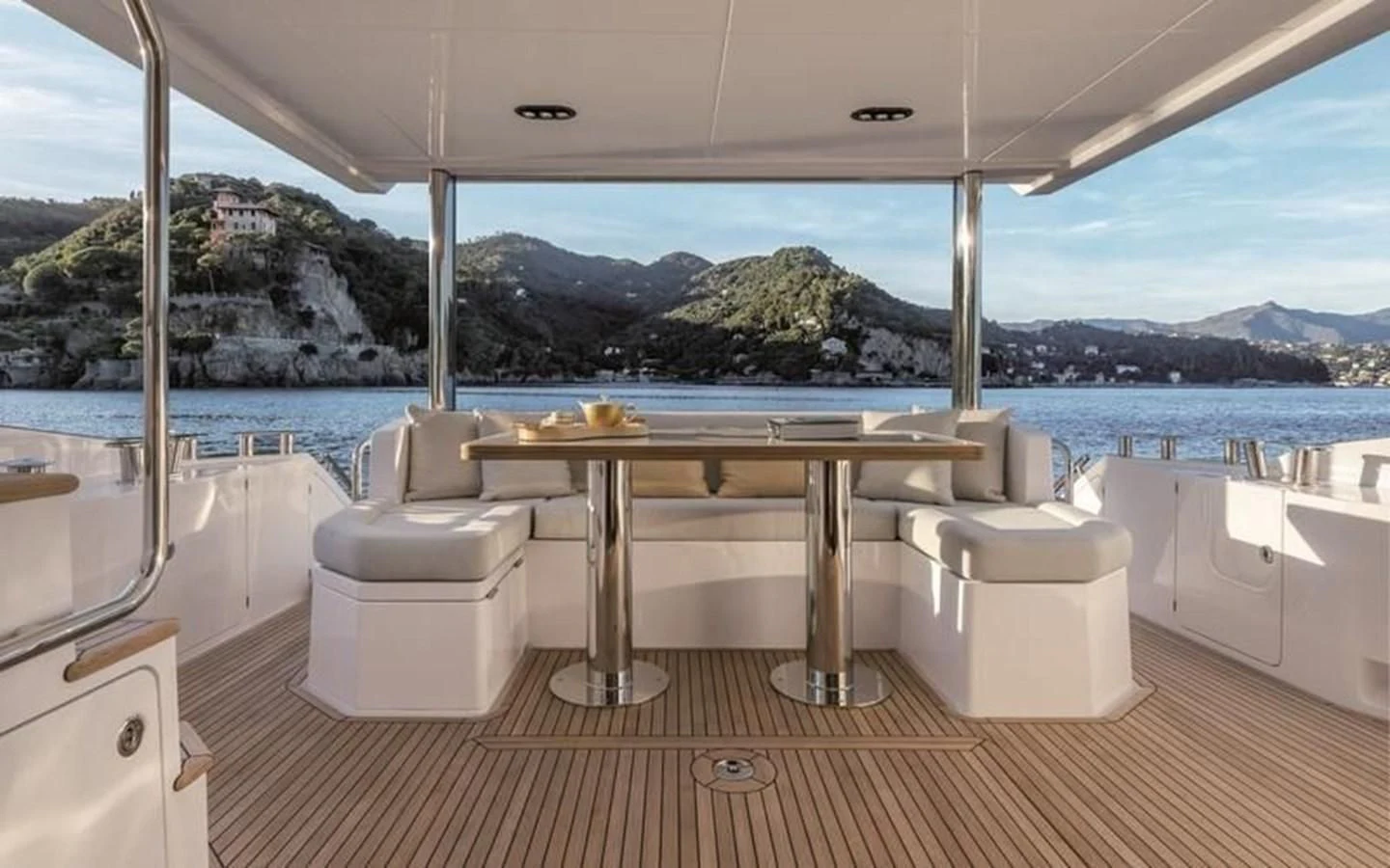 a room with a table and chairs aboard INFINITE VOYAGE III Yacht for Sale