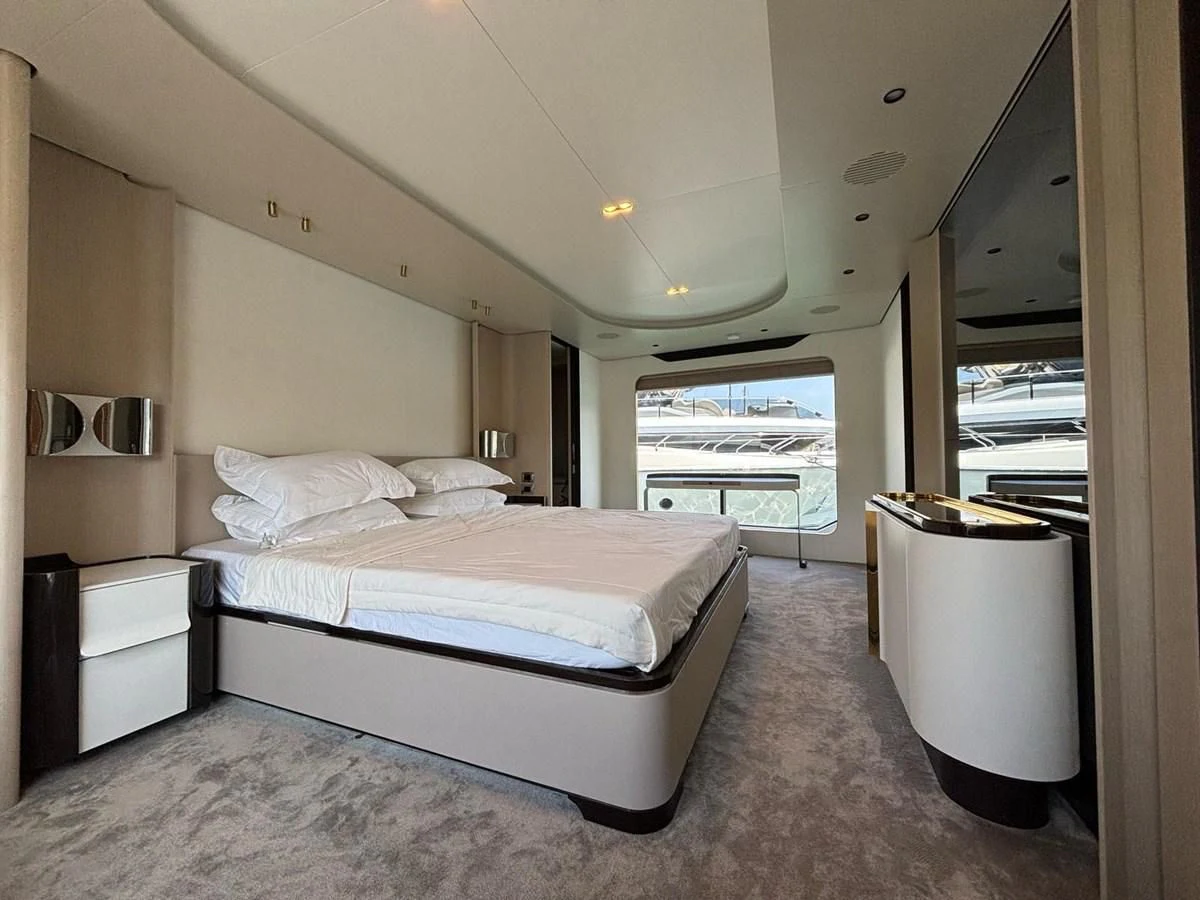 a bedroom with a large bed aboard INFINITE VOYAGE III Yacht for Sale