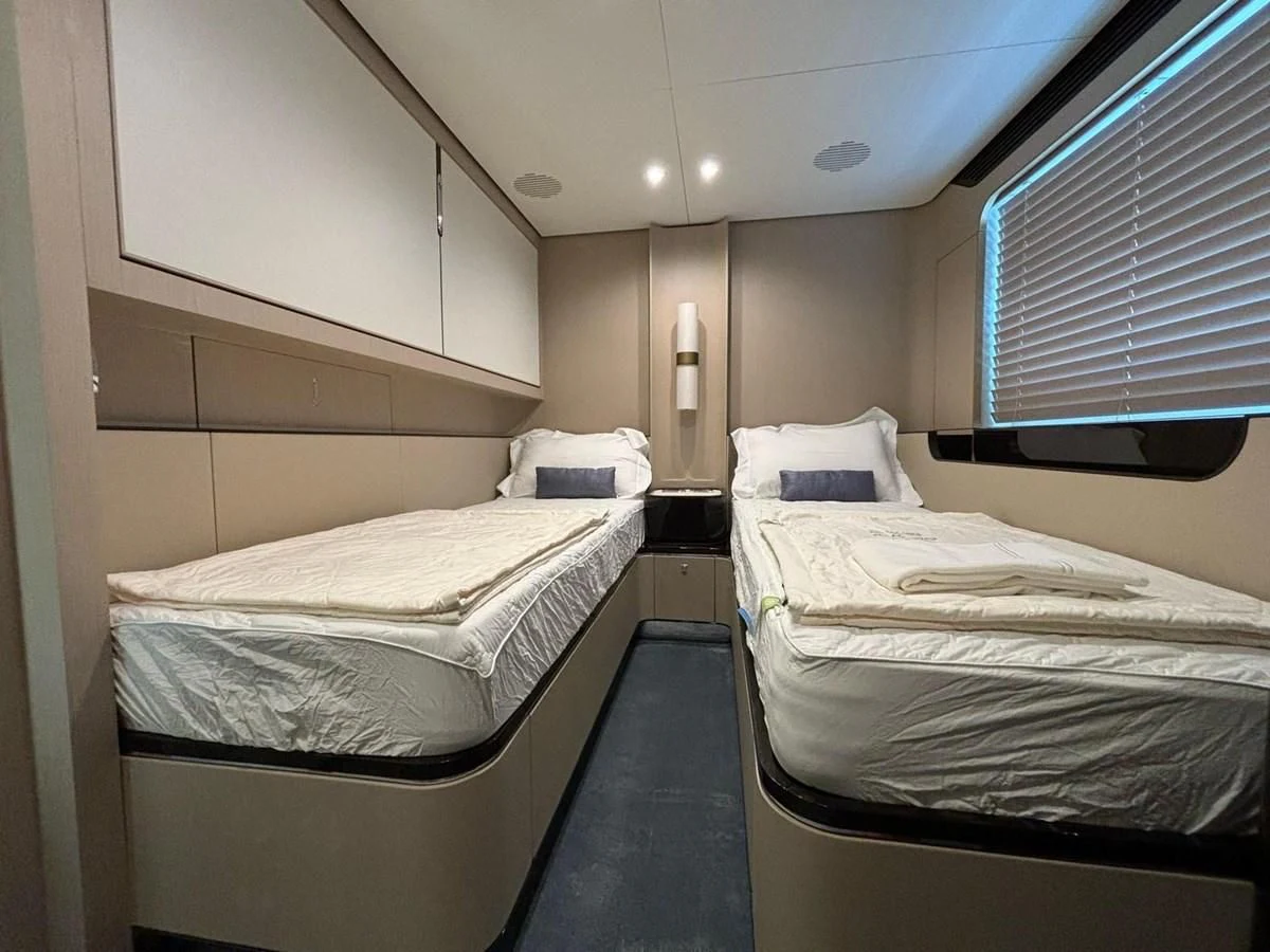 a room with two beds aboard INFINITE VOYAGE III Yacht for Sale