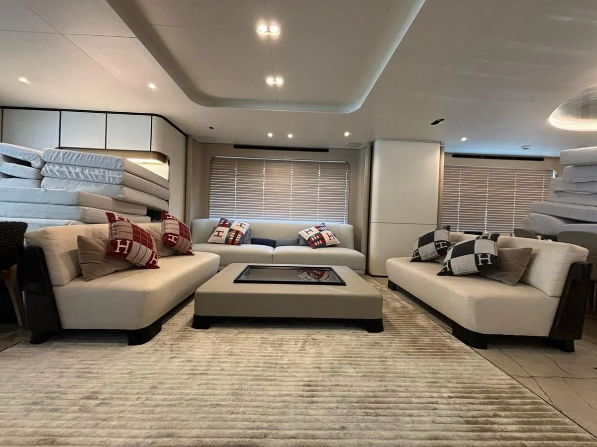a living room with white couches aboard INFINITE VOYAGE III Yacht for Sale