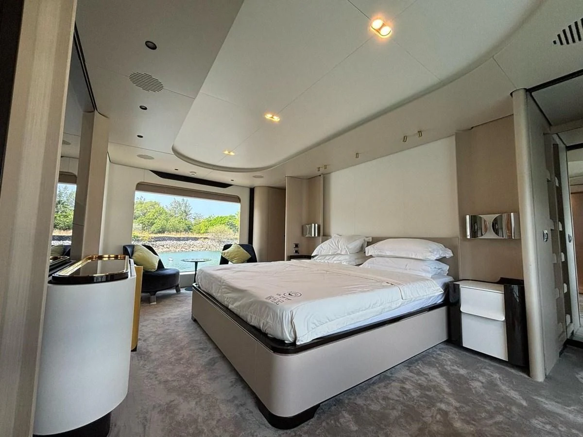 a bedroom with a large bed aboard INFINITE VOYAGE III Yacht for Sale