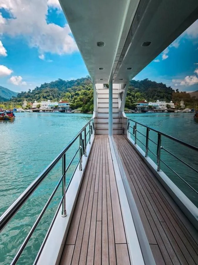 a wooden walkway over water aboard INFINITE VOYAGE III Yacht for Sale