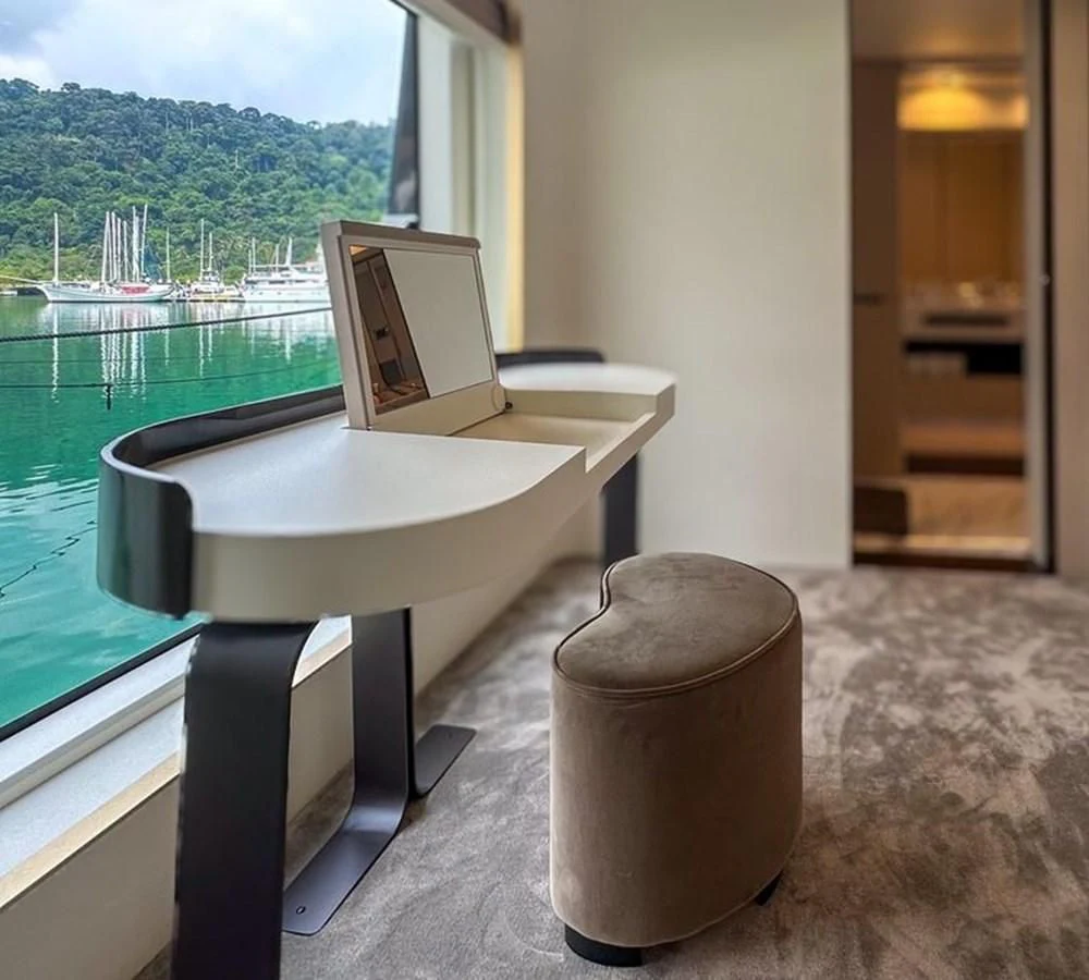 a table with a laptop on it aboard INFINITE VOYAGE III Yacht for Sale