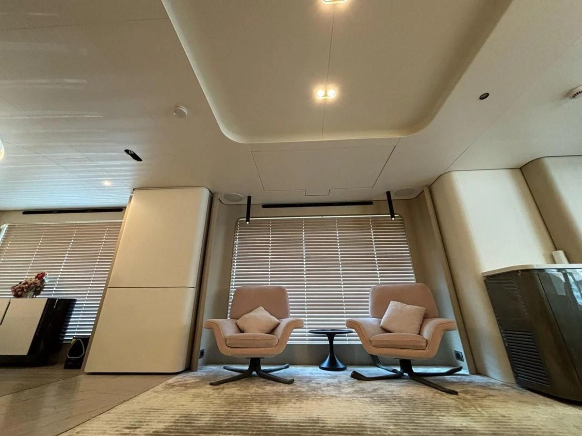 a room with a couch and a chair aboard INFINITE VOYAGE III Yacht for Sale