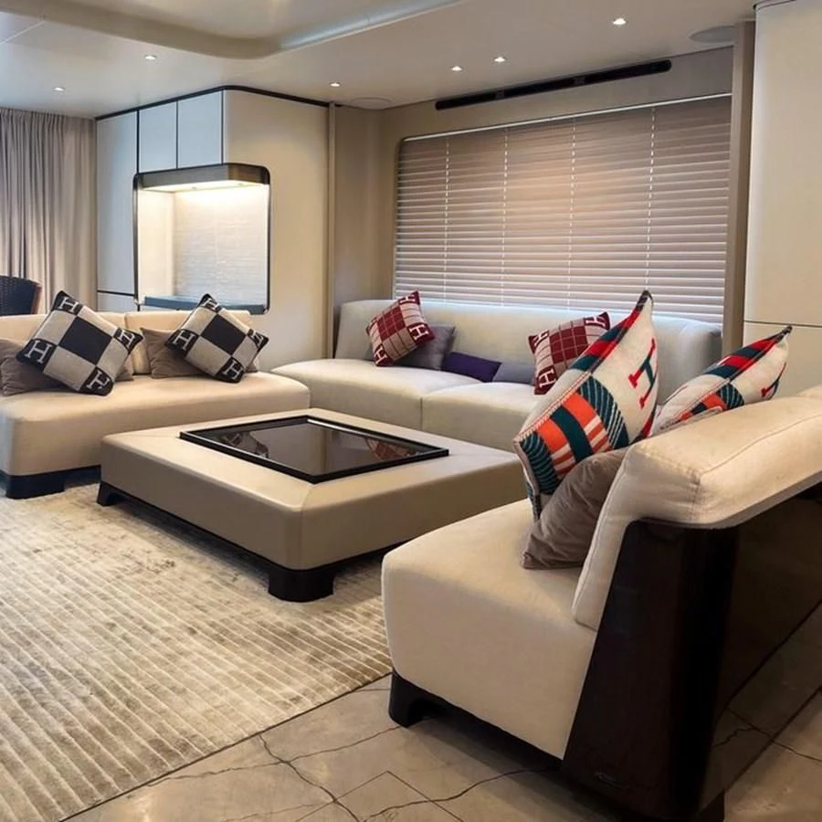 a living room with a couch and a coffee table aboard INFINITE VOYAGE III Yacht for Sale