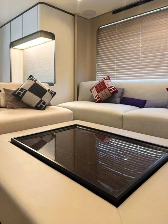 a living room with a couch and a television aboard INFINITE VOYAGE III Yacht for Sale