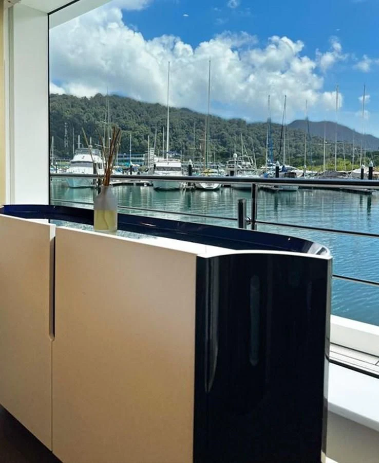 a window with a view of a city and water aboard INFINITE VOYAGE III Yacht for Sale