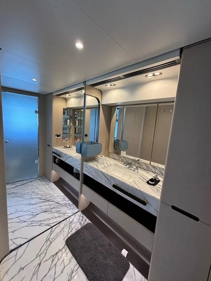 a large bathroom with a large mirror aboard INFINITE VOYAGE III Yacht for Sale