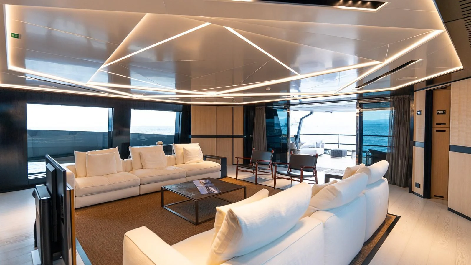 a room with a couch and a table and a window aboard EYE OF DESTINY Yacht for Sale
