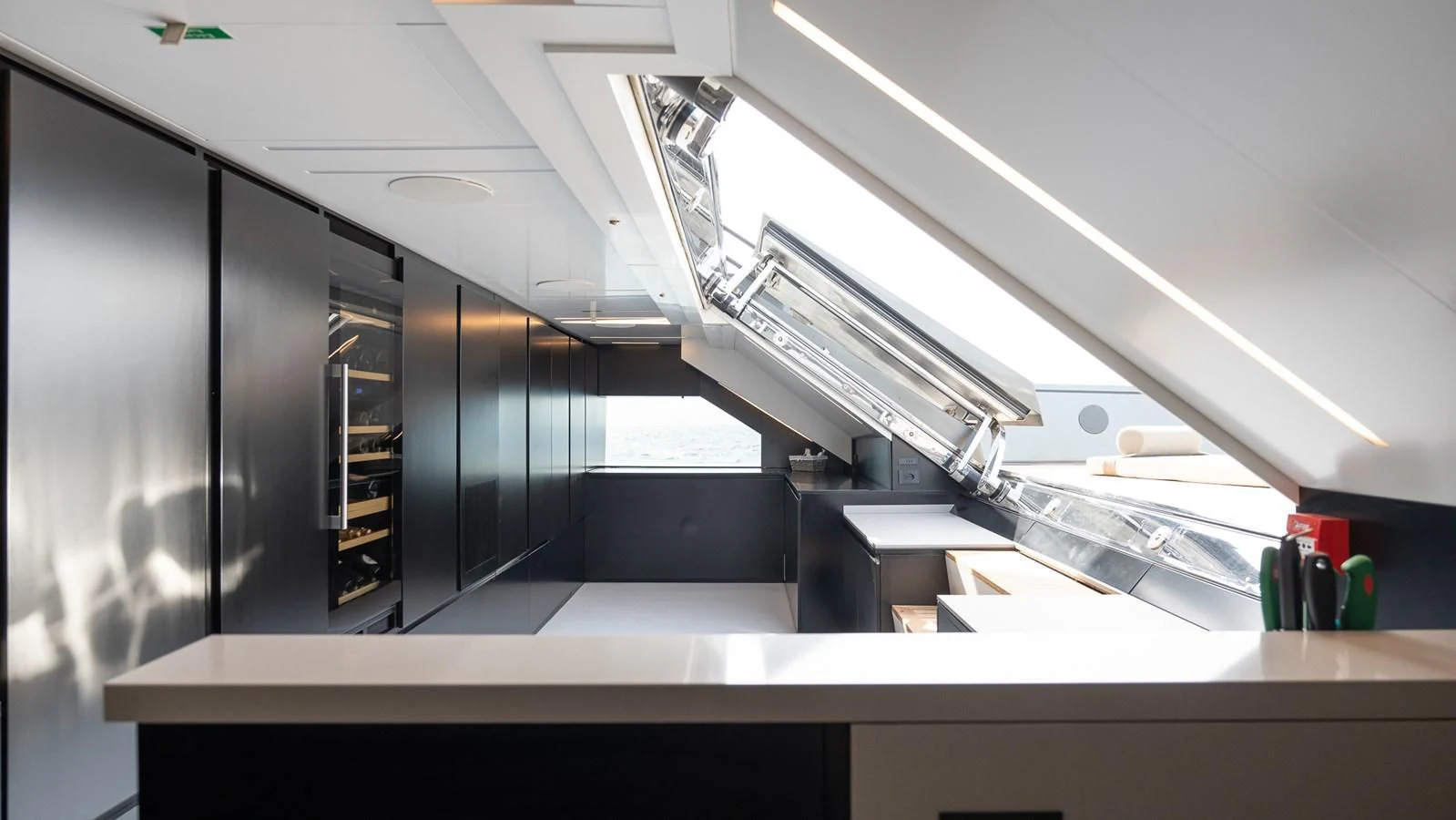 a large black cabinet with a ladder aboard EYE OF DESTINY Yacht for Sale