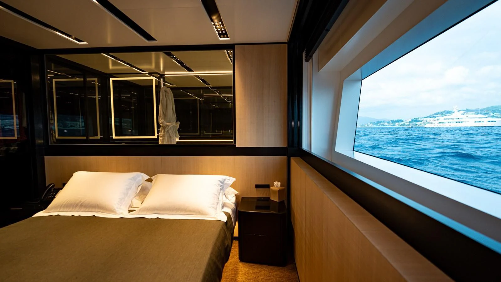 a room with a bed and a window aboard EYE OF DESTINY Yacht for Sale