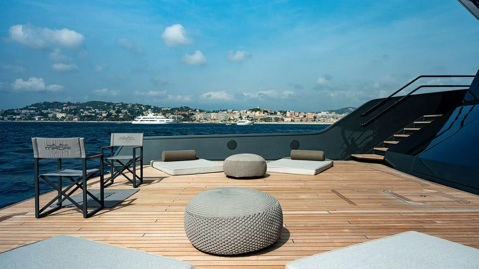 a deck with chairs and a large body of water in the background aboard EYE OF DESTINY Yacht for Sale