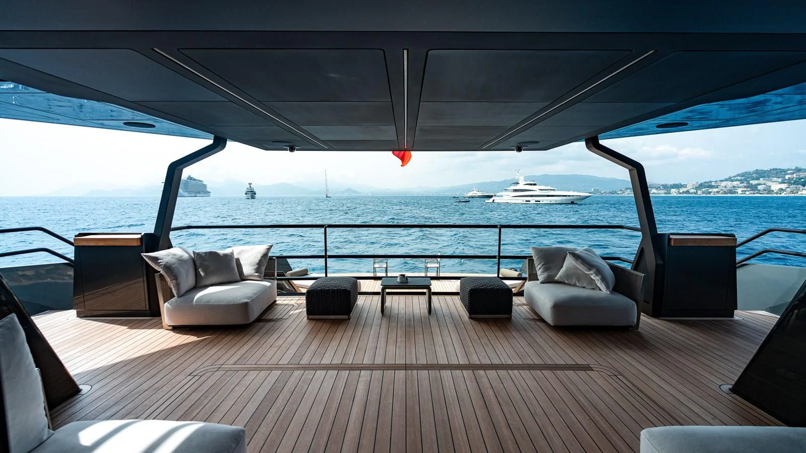 a deck with a view of the ocean and a large ship aboard EYE OF DESTINY Yacht for Sale