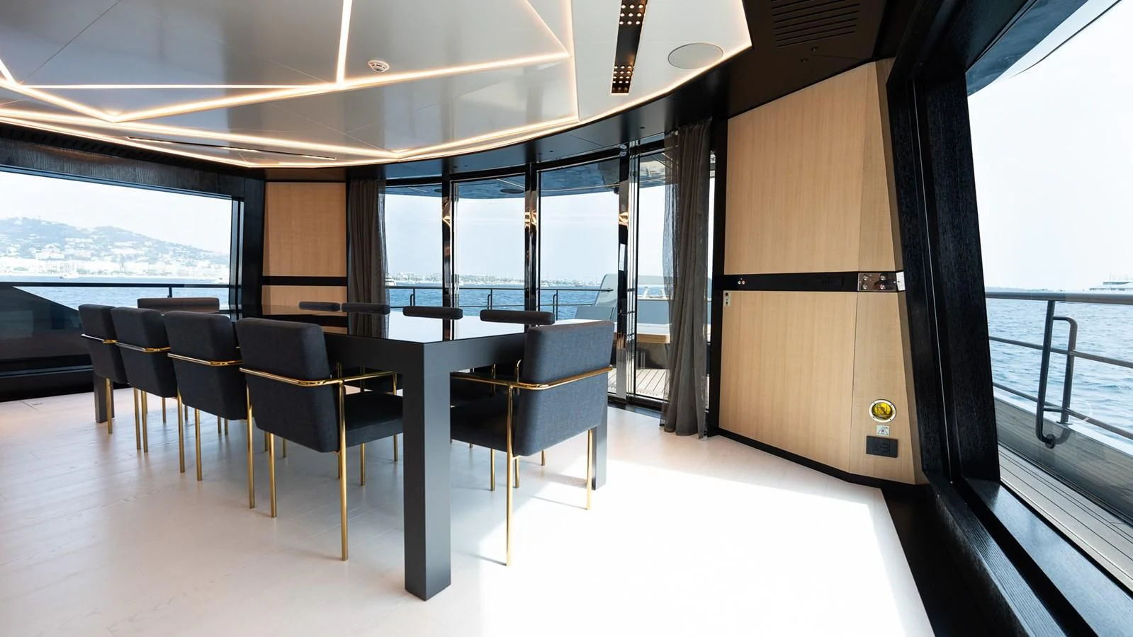 a room with a table and chairs aboard EYE OF DESTINY Yacht for Sale
