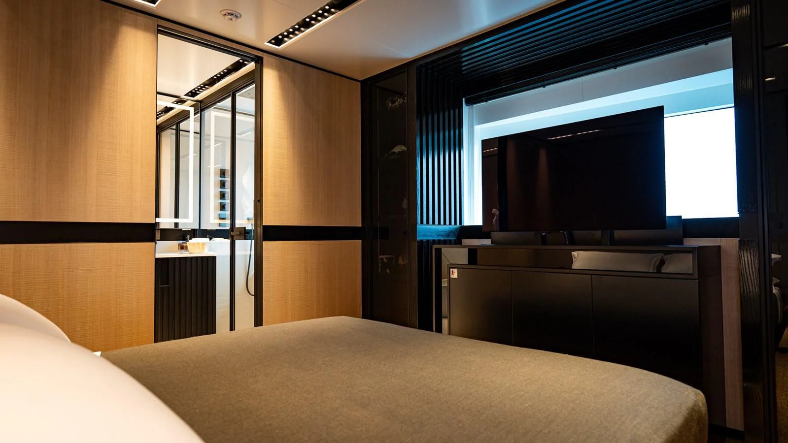 a room with a bed and a tv aboard EYE OF DESTINY Yacht for Sale