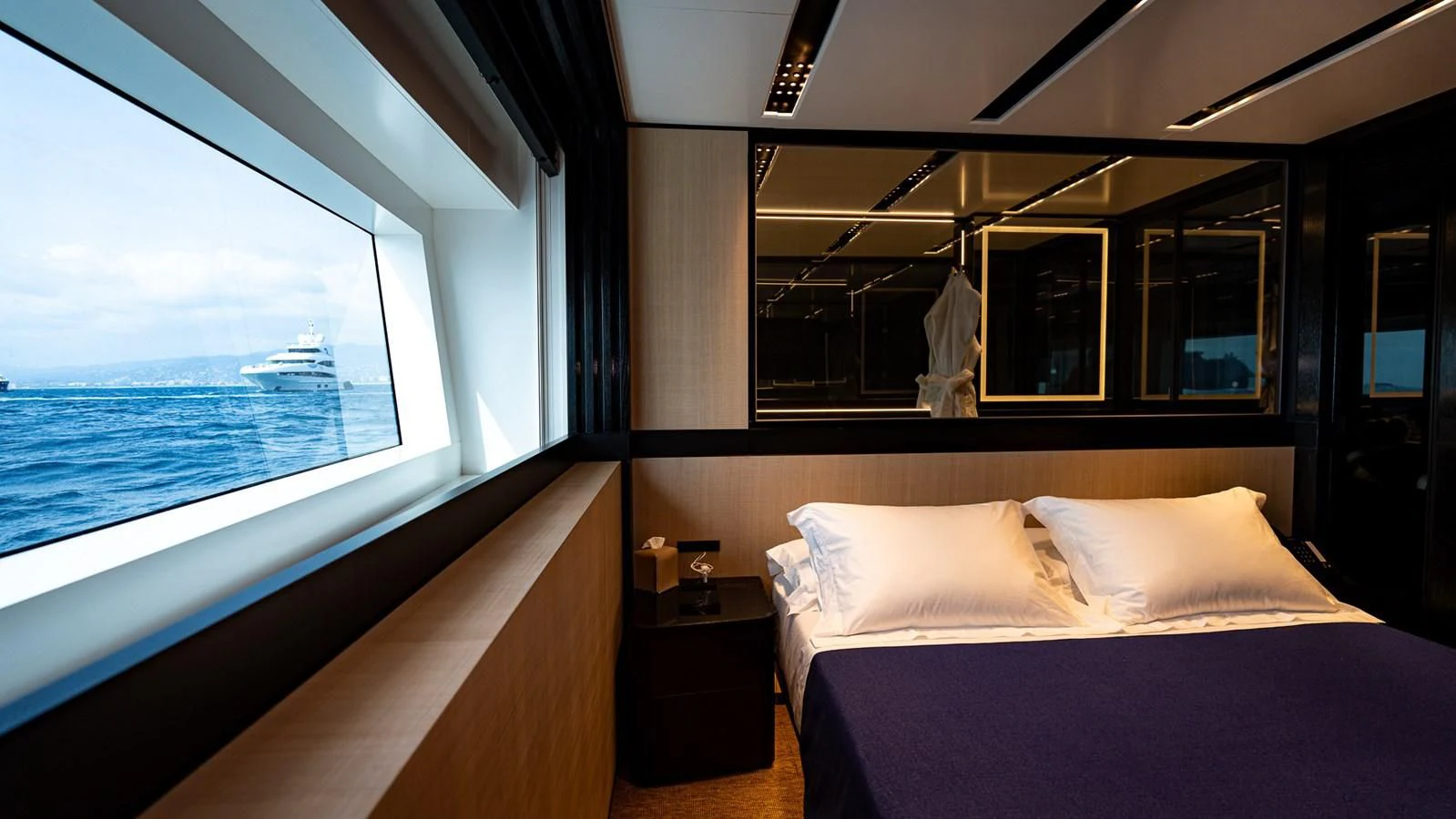 a room with a bed and a window aboard EYE OF DESTINY Yacht for Sale