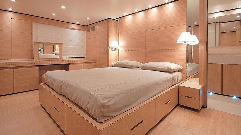 a large bedroom with a bed aboard BOLARO Yacht for Sale