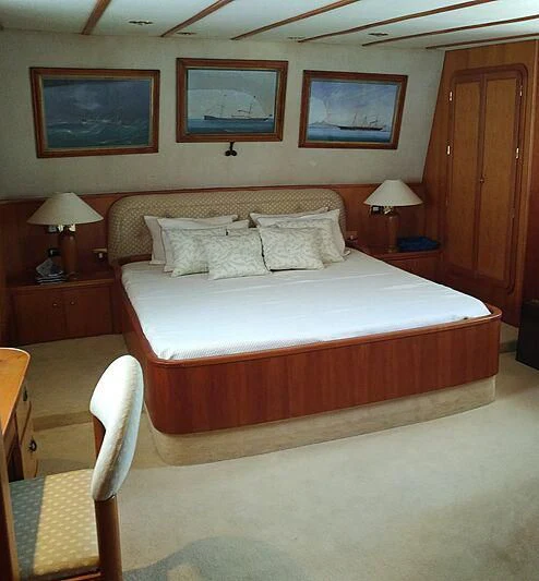 a bed with a white comforter aboard LA GRANDE DAME Yacht for Sale