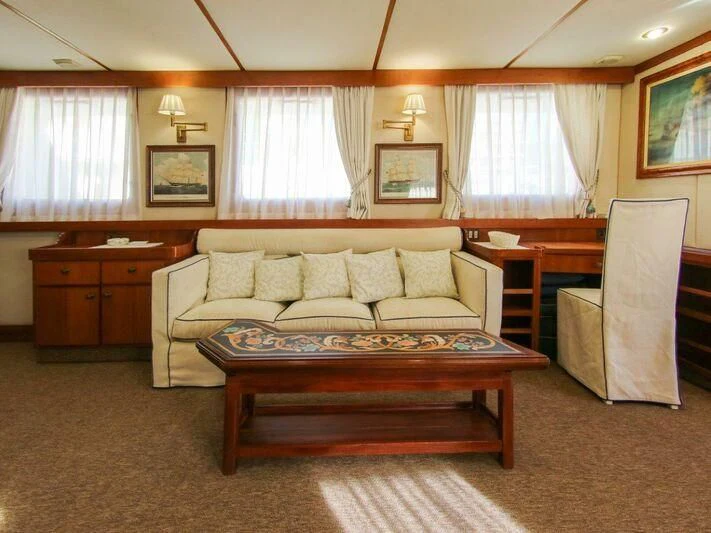 a living room with a couch and a table aboard LA GRANDE DAME Yacht for Sale