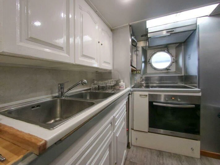 a kitchen with a stove and sink aboard LA GRANDE DAME Yacht for Sale