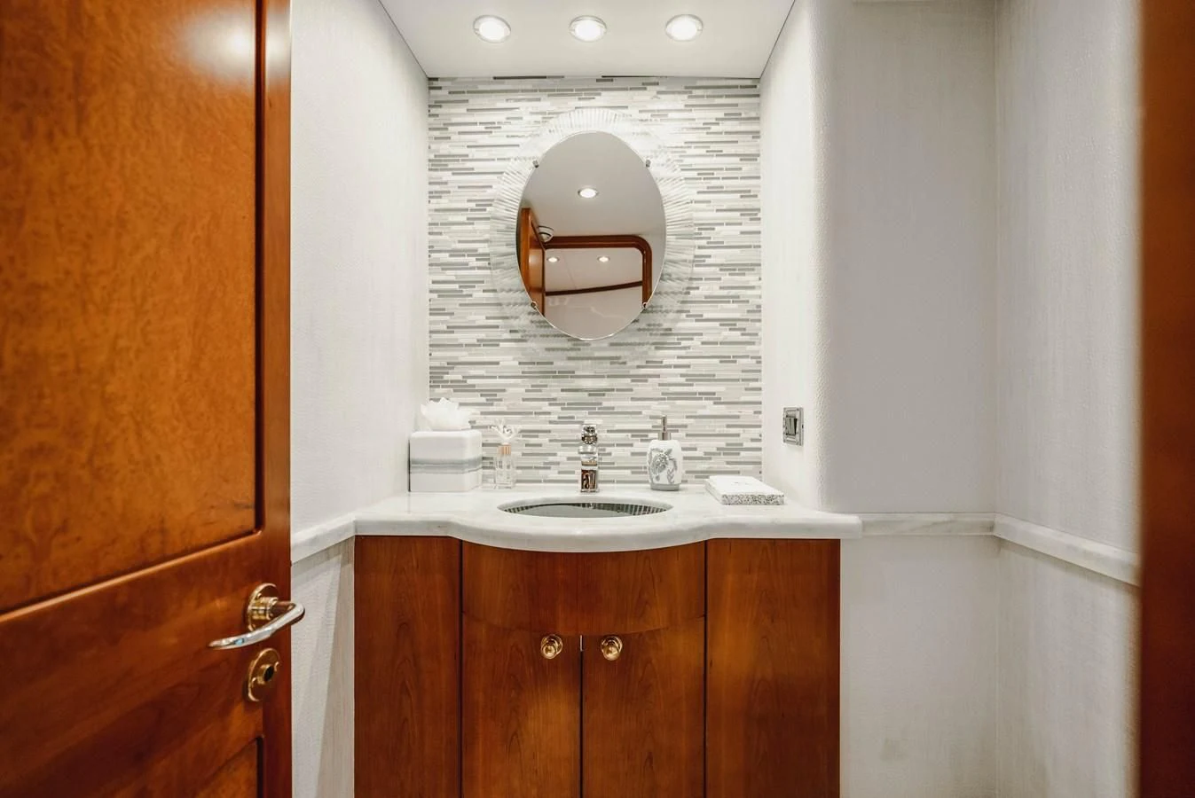 a bathroom with a sink and a mirror aboard LA LADY Yacht for Sale