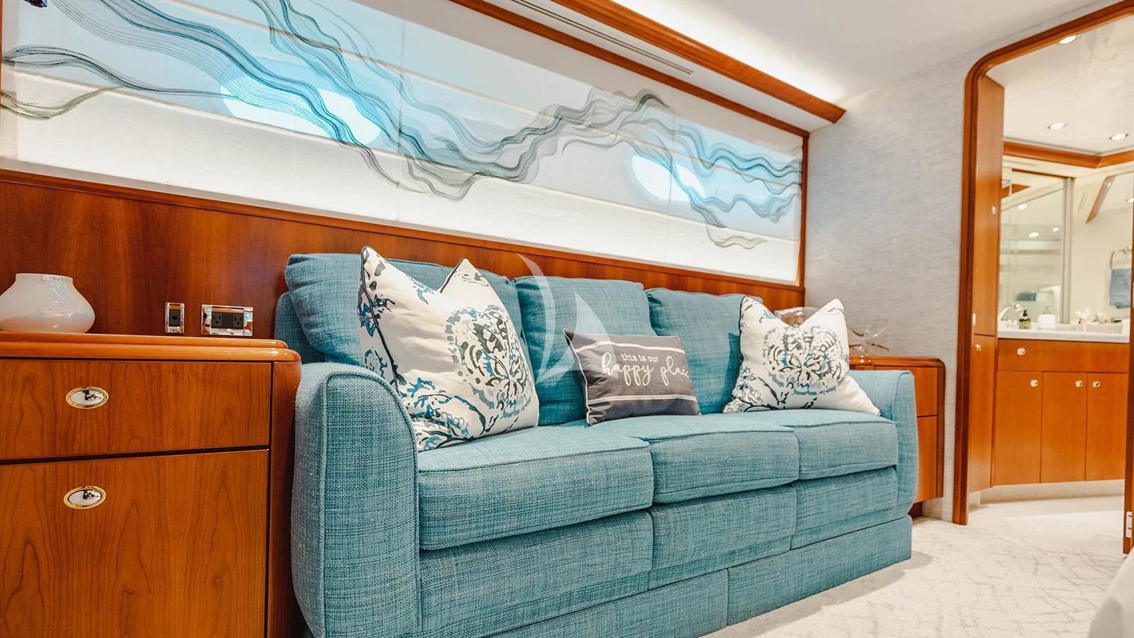 a blue couch with white pillows aboard LA LADY Yacht for Sale