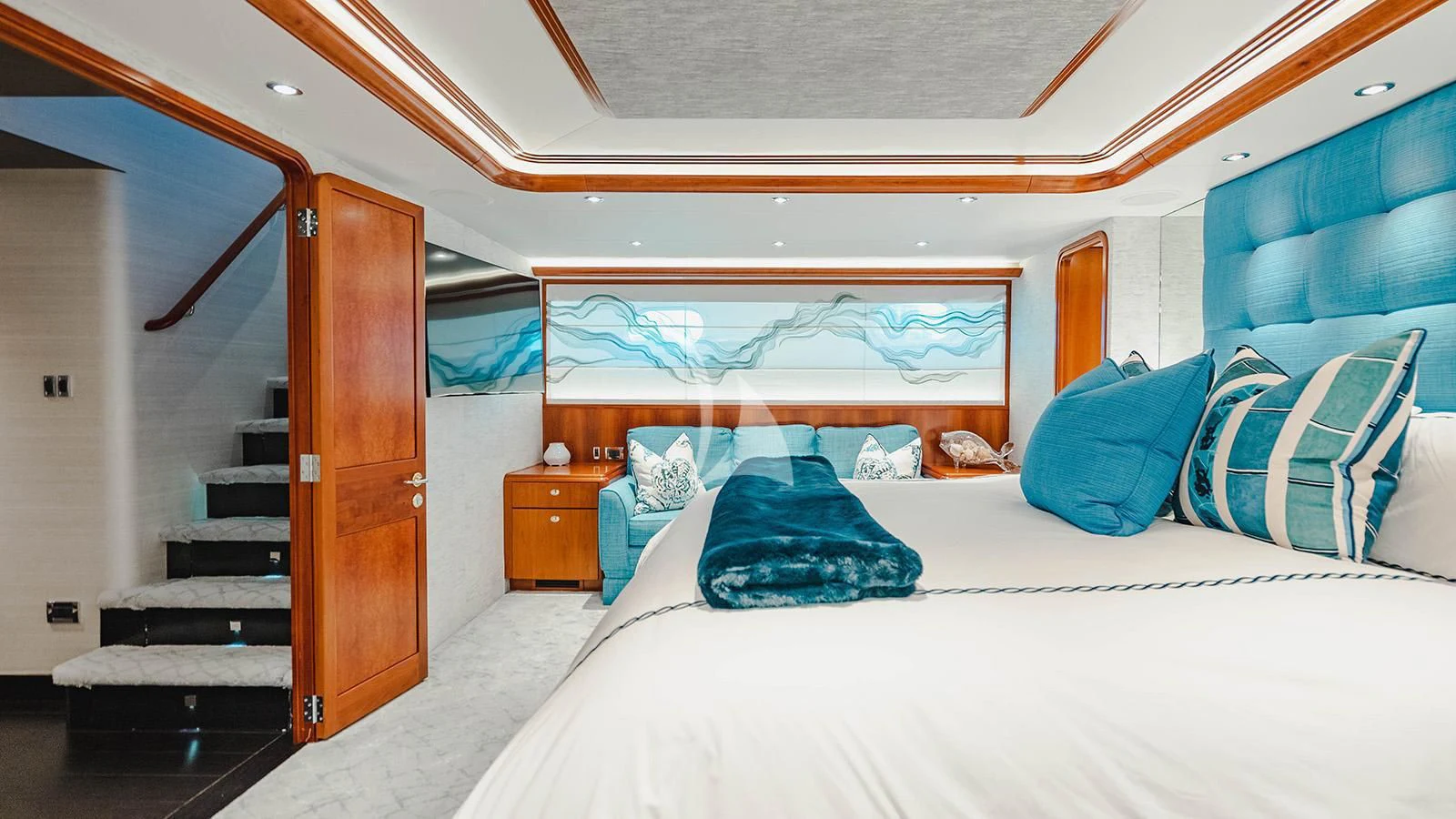 a bedroom with a bed and a wood door aboard LA LADY Yacht for Sale