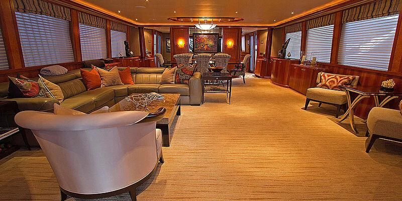 a living room with a large wood floor and a large window aboard LA LADY Yacht for Sale