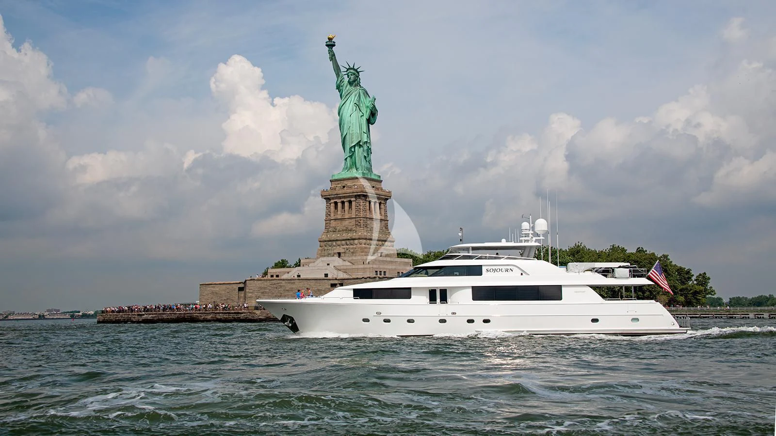 a boat in the water with a statue of liberty in the background aboard LA LADY Yacht for Sale