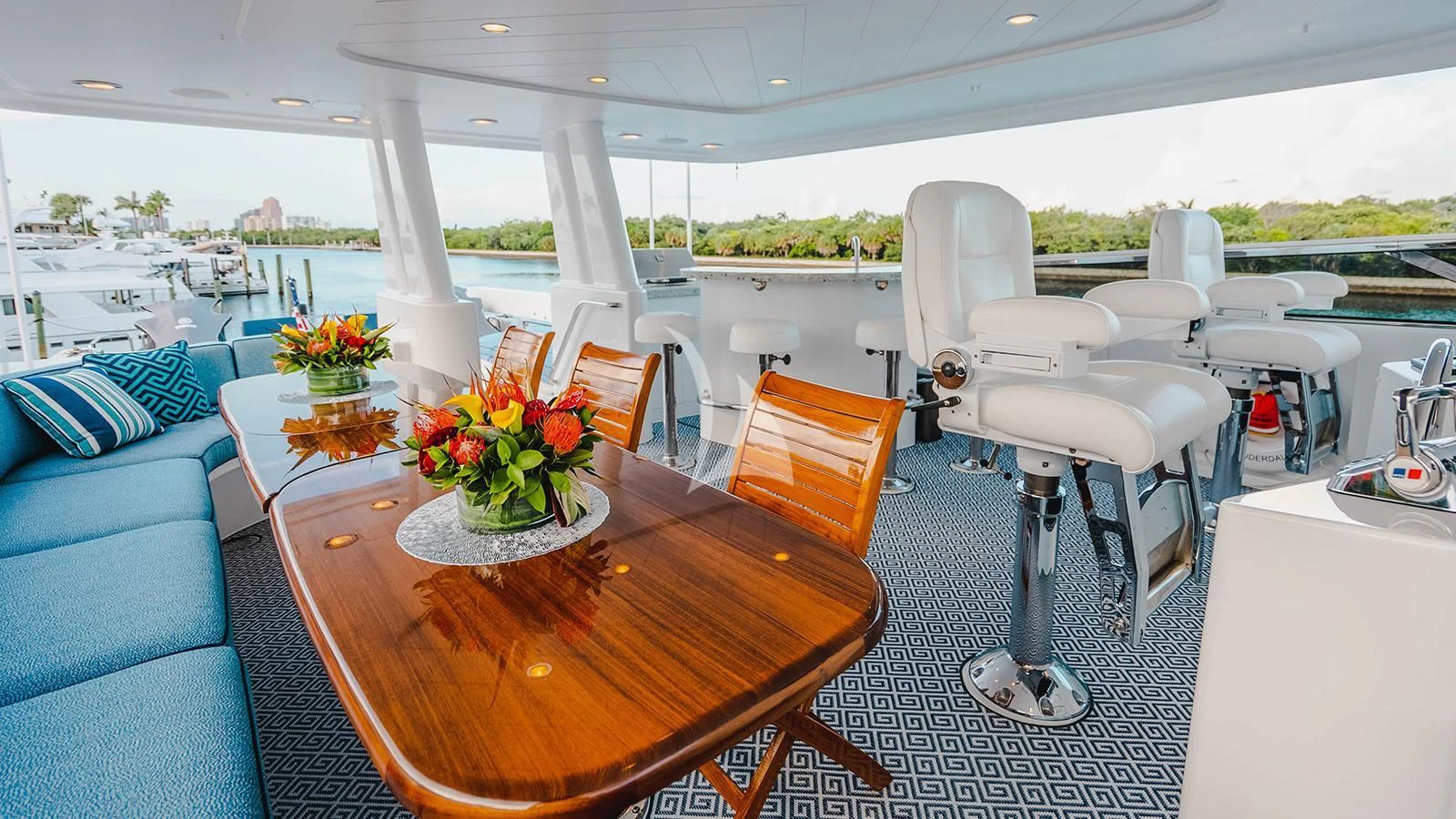 a table with chairs and a couch aboard LA LADY Yacht for Sale