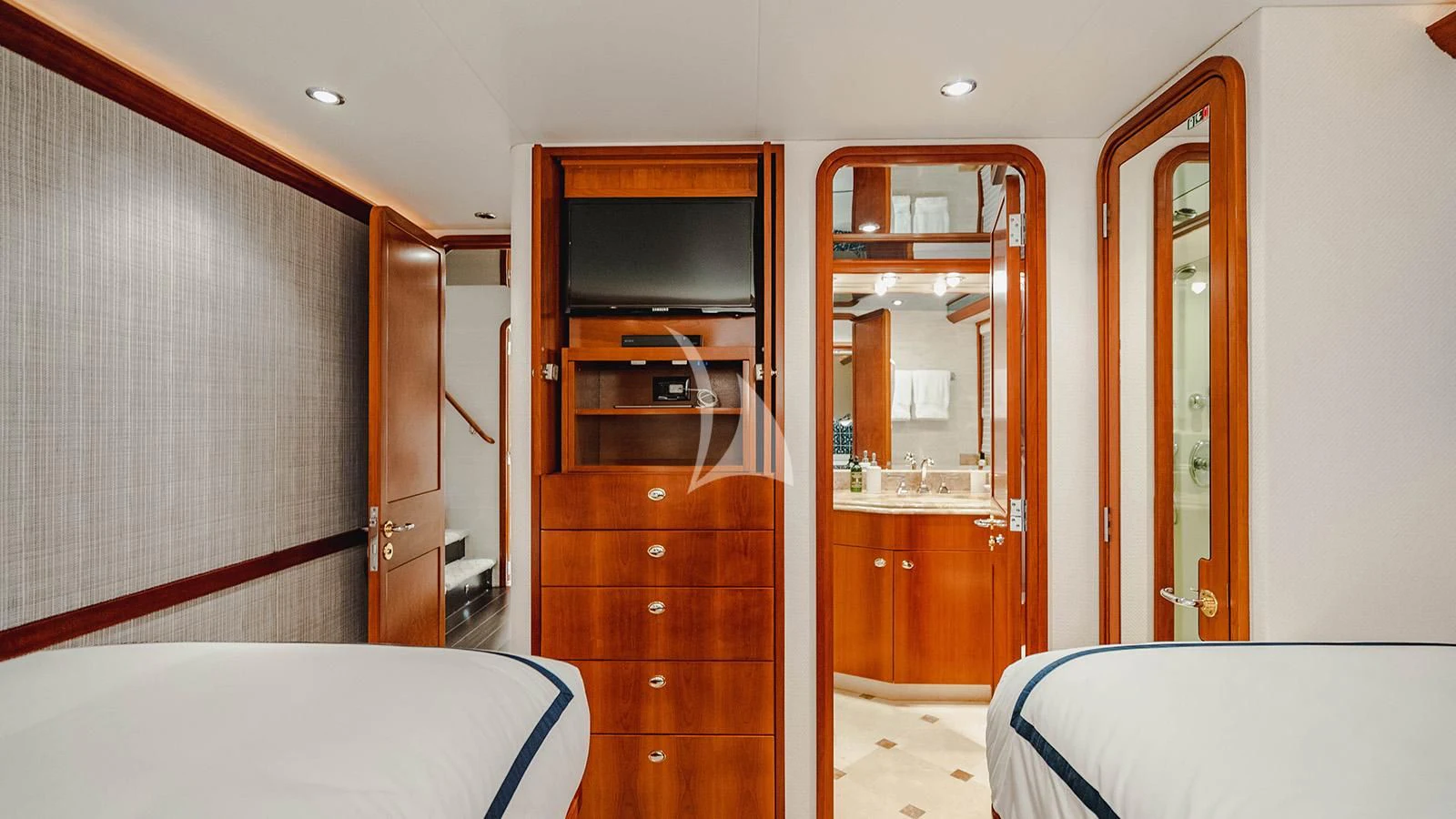 a room with a bed and a television aboard LA LADY Yacht for Sale