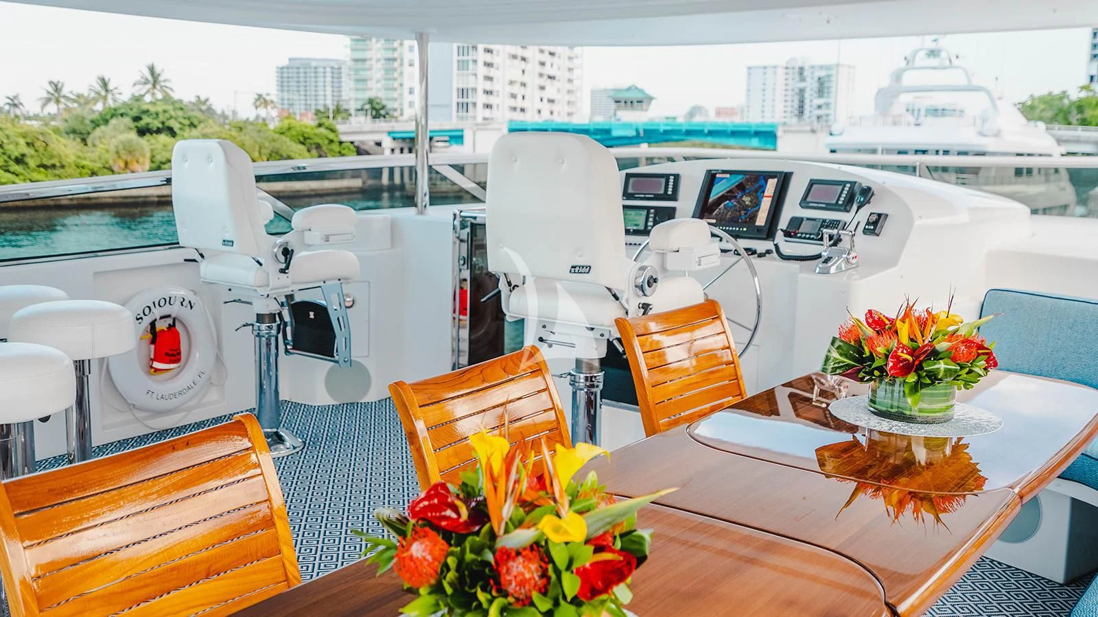 a boat with a table and chairs aboard LA LADY Yacht for Sale