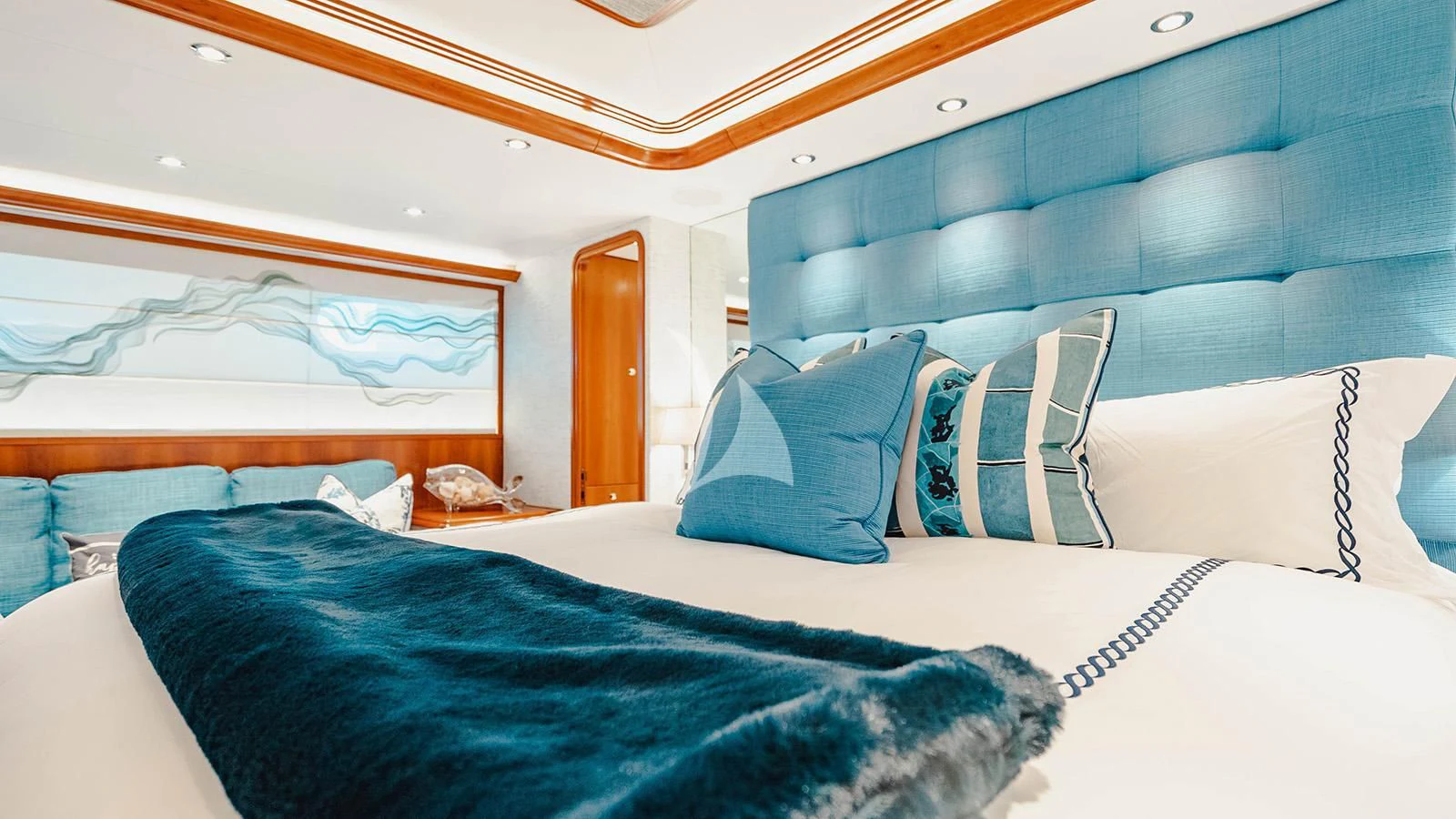 a room with a bed and a blue pillow aboard LA LADY Yacht for Sale
