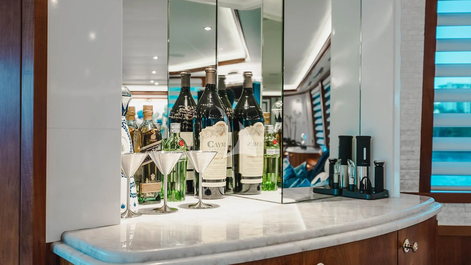 a counter with bottles and glasses aboard LA LADY Yacht for Sale