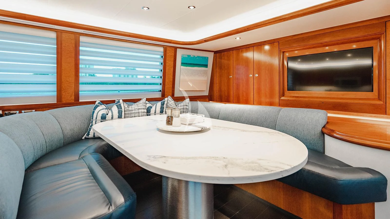 a room with a table and chairs aboard LA LADY Yacht for Sale
