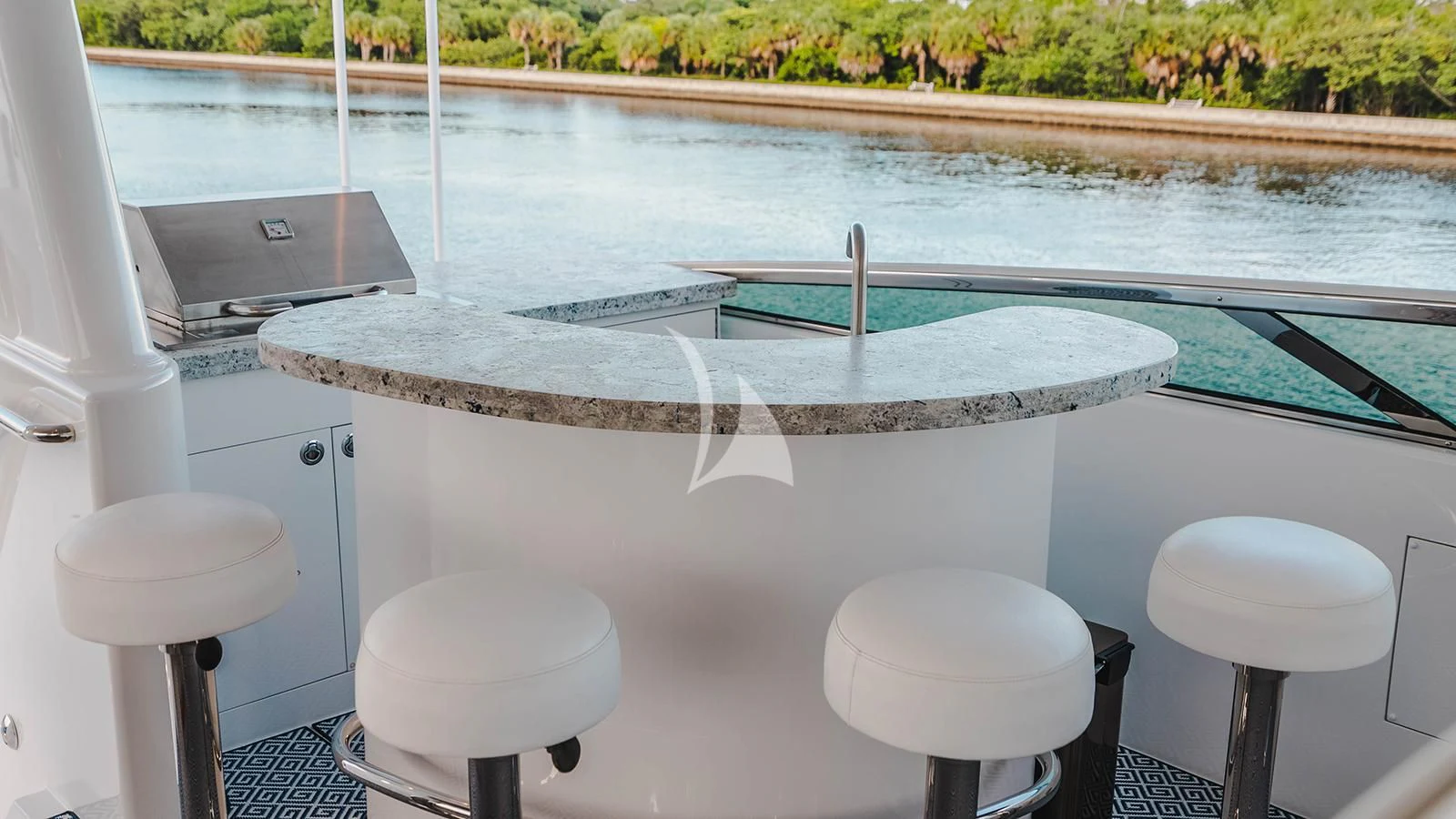 a table with stools by a pool aboard LA LADY Yacht for Sale