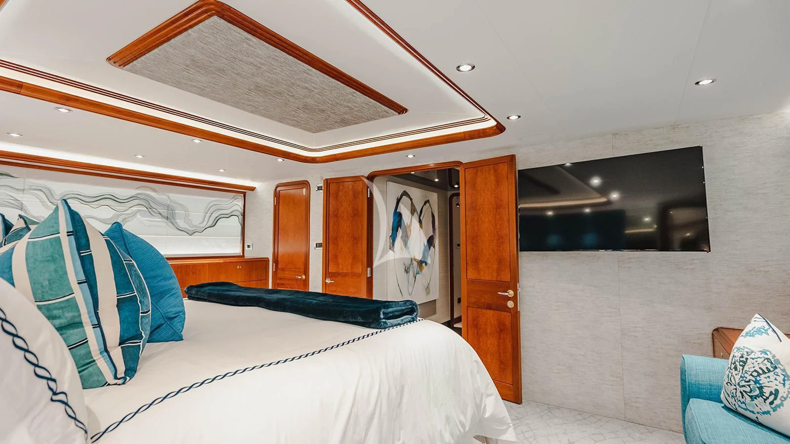 a room with a bed and a television aboard LA LADY Yacht for Sale
