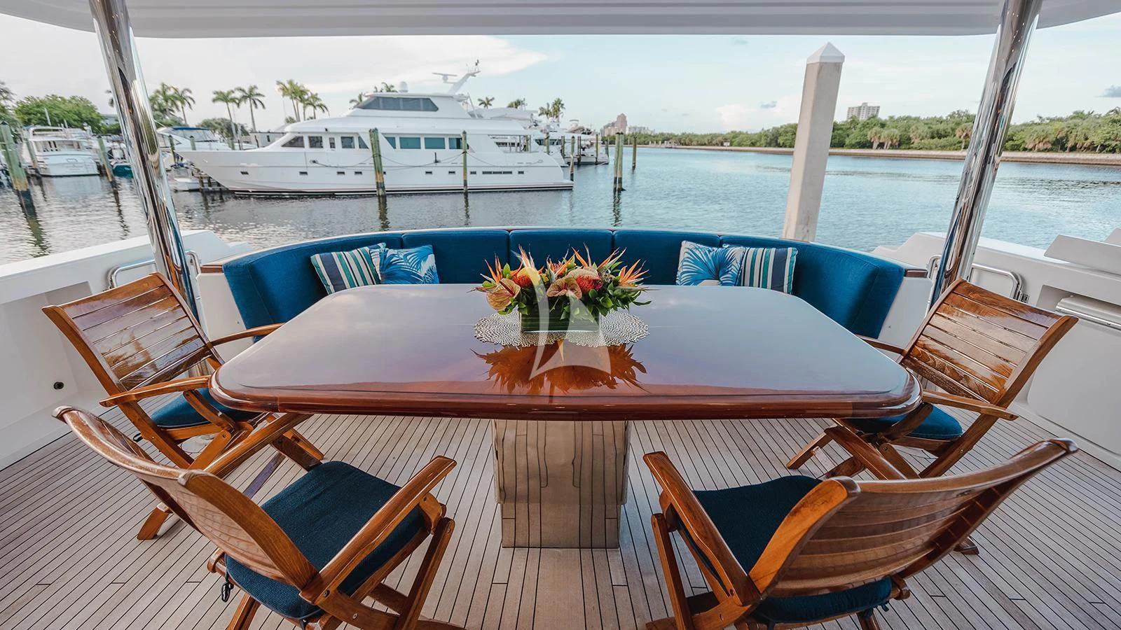 a table with chairs on it next to a body of water aboard LA LADY Yacht for Sale