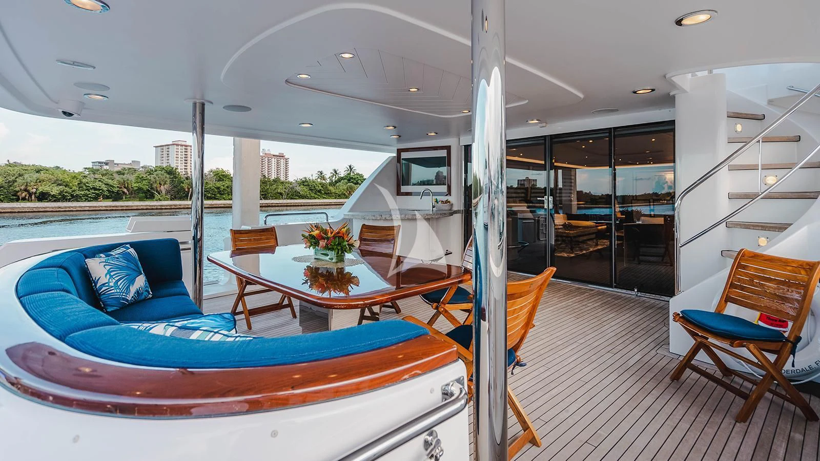 a large living room with a large blue couch and a table aboard LA LADY Yacht for Sale
