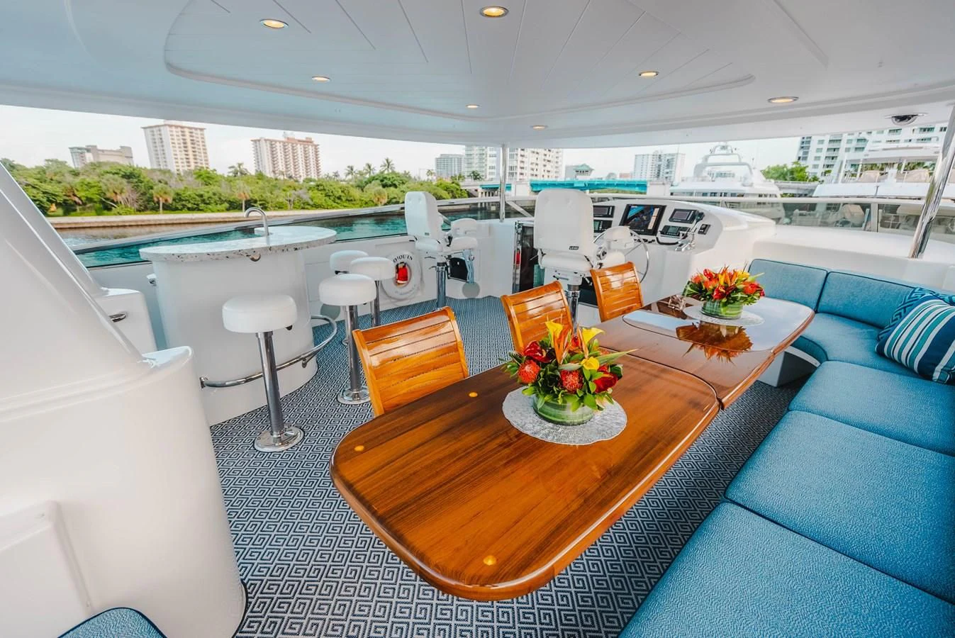 a room with a table chairs and a couch aboard LA LADY Yacht for Sale