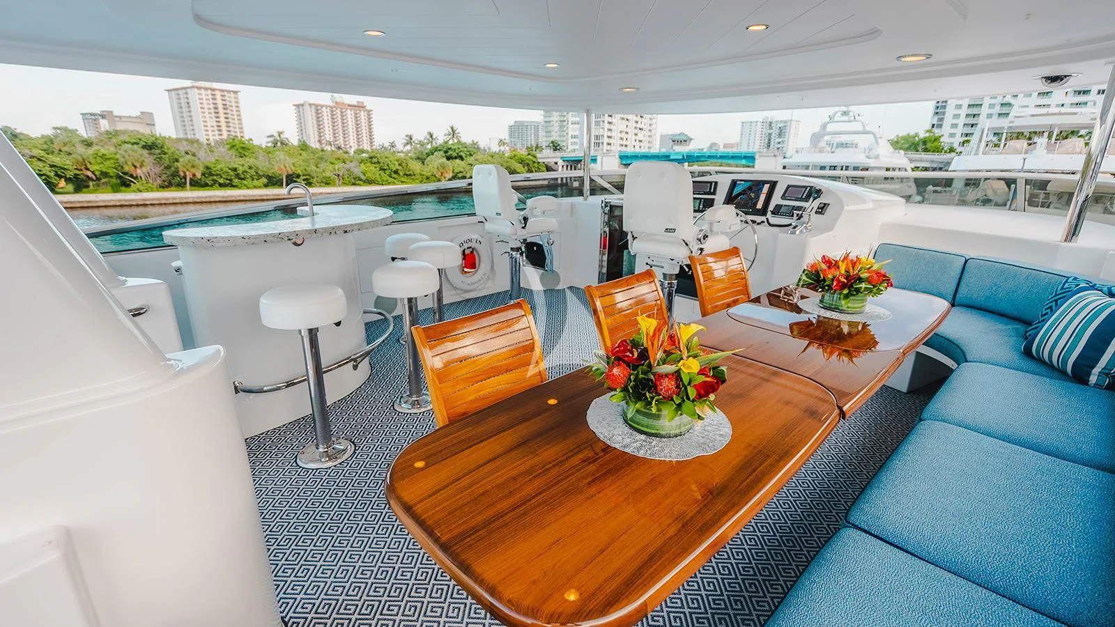 a table with chairs and a couch aboard LA LADY Yacht for Sale