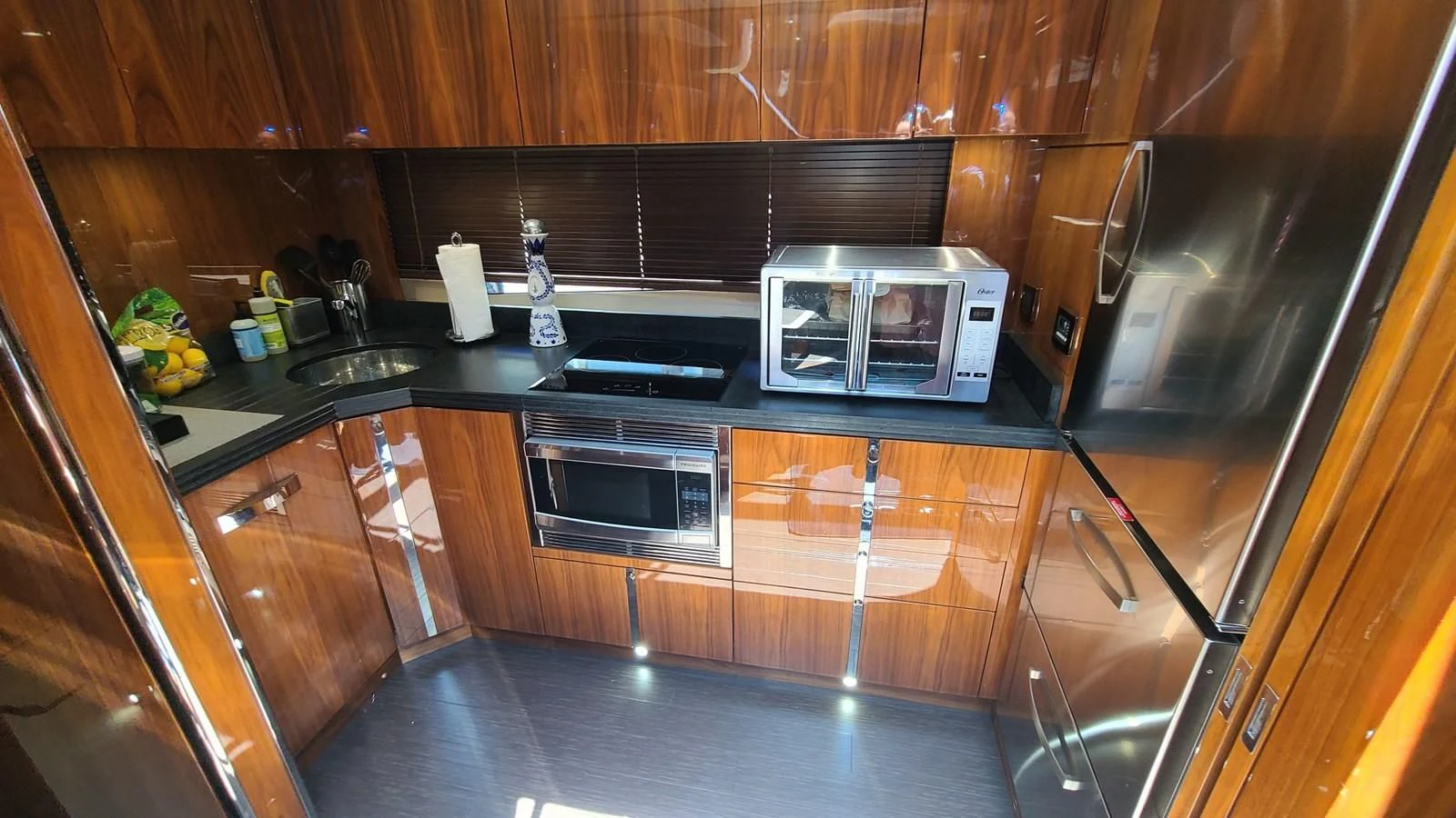 a kitchen with wooden cabinets aboard PREDATOR 68 Yacht for Sale