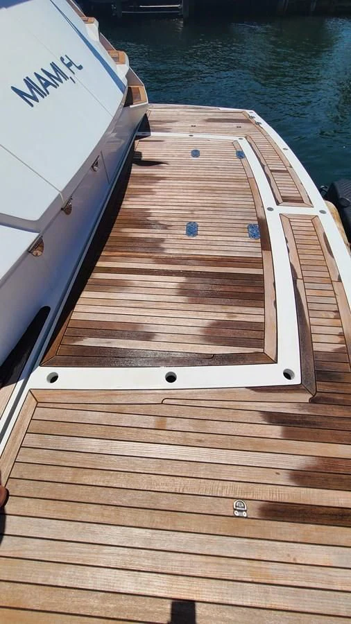 a wooden boat on a dock aboard PREDATOR 68 Yacht for Sale
