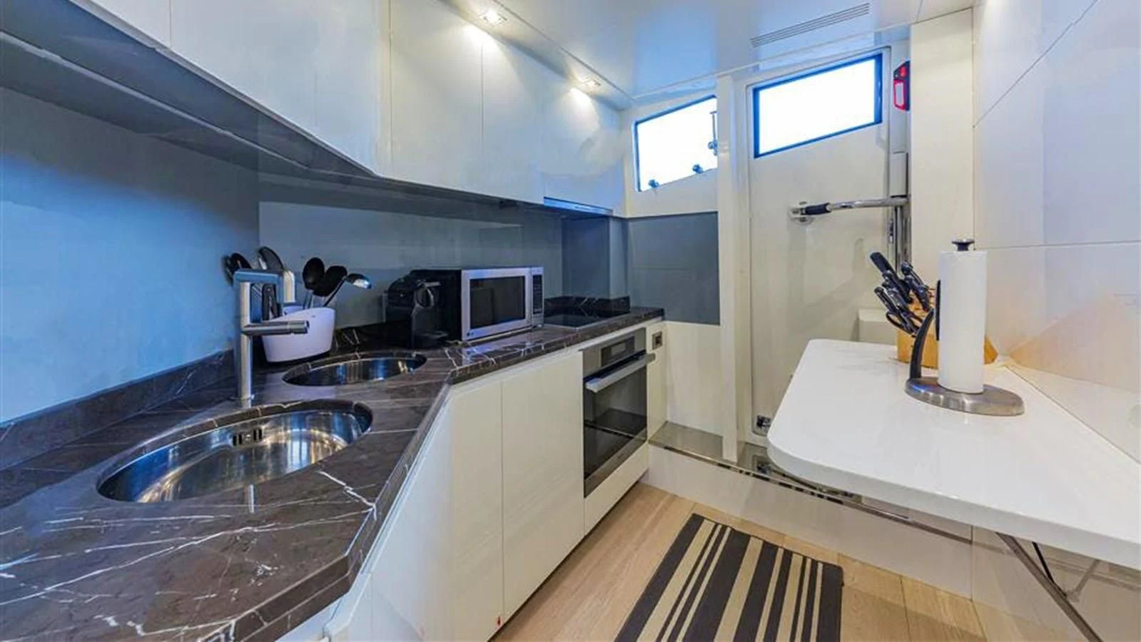a kitchen with a sink and a microwave aboard GOLDEN 3 Yacht for Sale