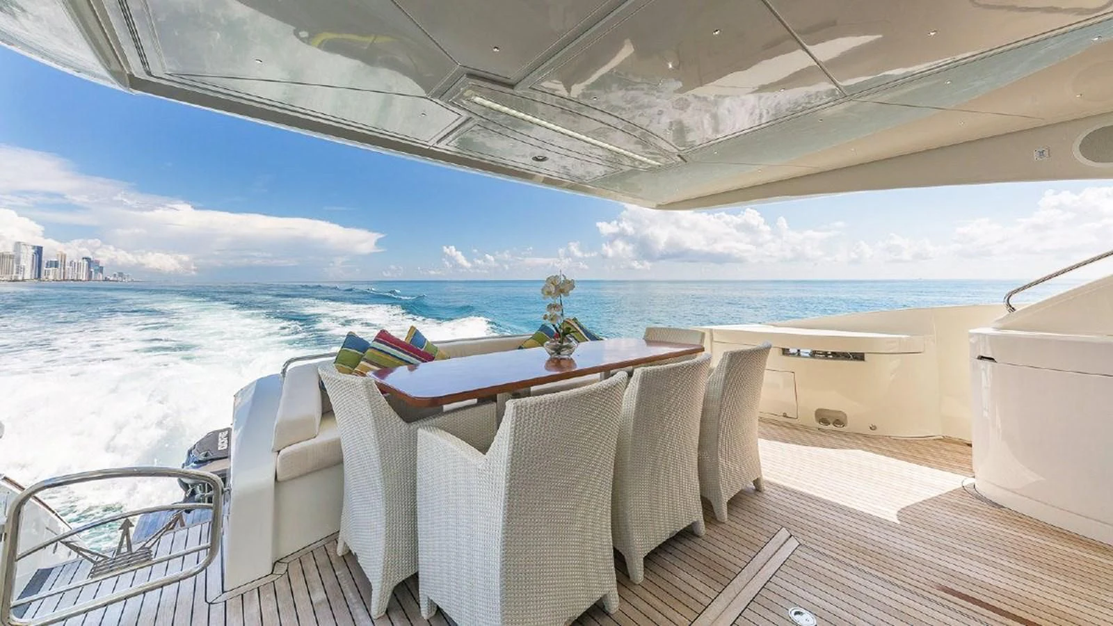 a table and chairs on a deck overlooking the ocean aboard GOLDEN 3 Yacht for Sale